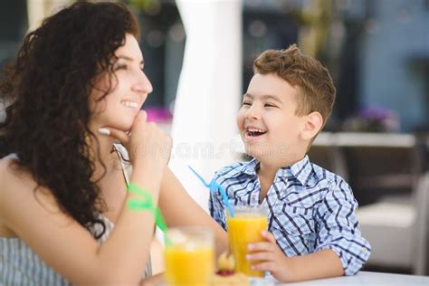 Boy And His Mother Tasting Dessert With Juice In Resort Restaurant Outdoor Stock Photo Image