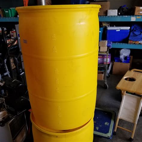 2 Yellow Plastic Drums 55 Gallons Each