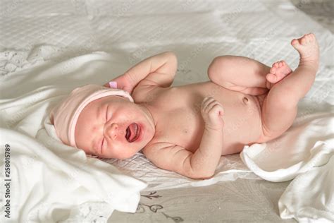 Newborn Naked Baby Crying On The Bed Stock Photo Adobe Stock