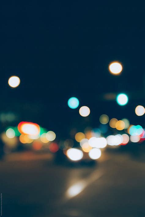 Car Headlights And Traffic Lights At Night Blurred Focus By Stocksy