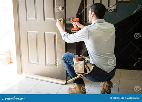 Young Man Fixing A Door Lock Stock Photo Image Of Lock Worker 102304438