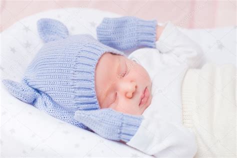 Sleeping Little Baby Wearing Knitted Blue Hat With Ears And Mittens