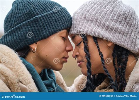 Dominican Lesbian Couple Showing Affection And Love At Street In Winter