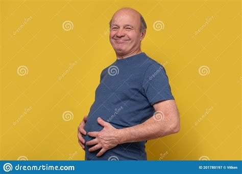 Fat Senior Man Touching His Big Abdomen With Hands After Well Eating