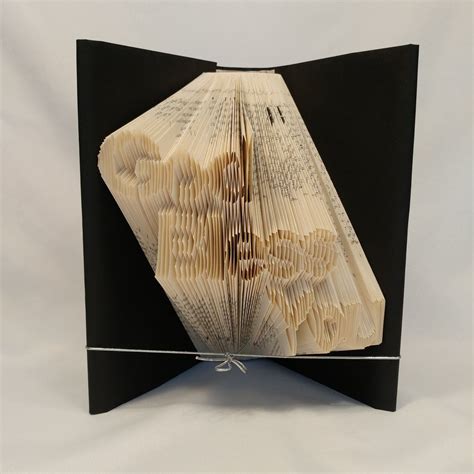 An Open Book That Has Been Folded To Look Like It Is Made Out Of Books