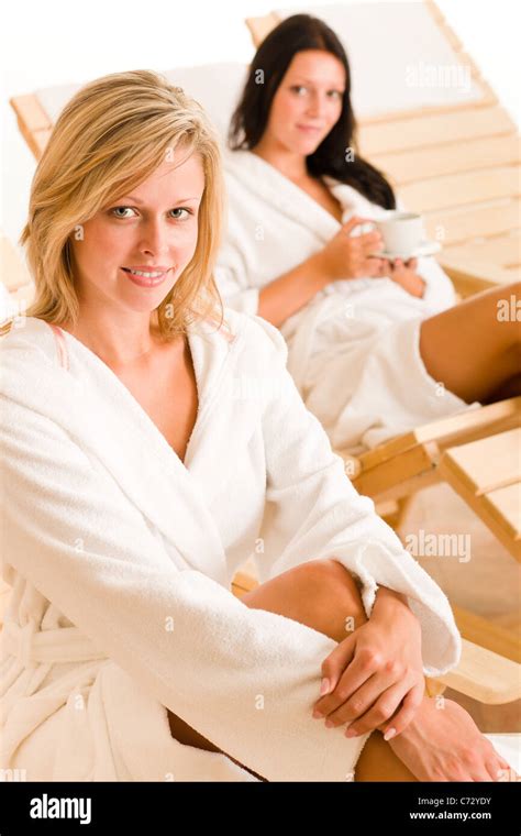 Two Beautiful Women Relax Sitting On Sun Beds Healthy Luxury Spa Stock