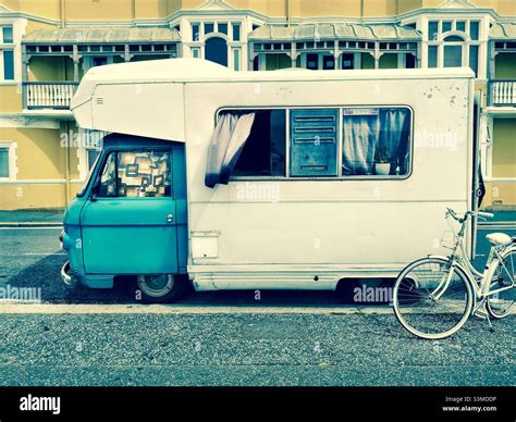 Vintage Camper Van Parked On City Street With Bicycle Stock Photo Alamy
