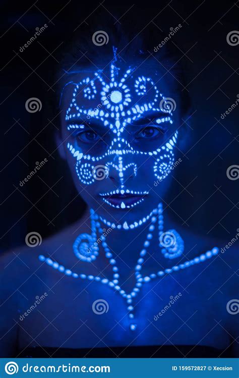 Body Art On The Body And Hand Of A Girl Glowing In The Ultraviolet