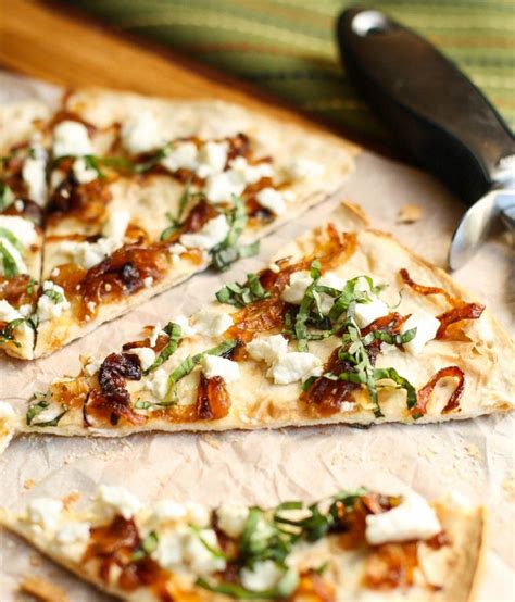 Flatbread With Goat Cheese And Caramelized Onions Garnish With Lemon