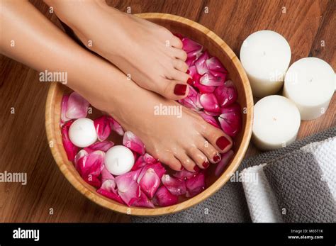 closeup photo of a female feet at spa salon on pedicure procedure female legs in water