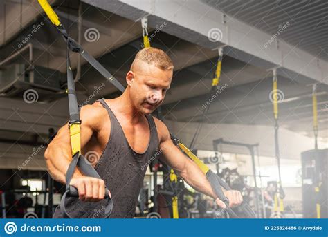 Muscular Man Working Out In Gym Doing Exercises Exercise For Triceps In