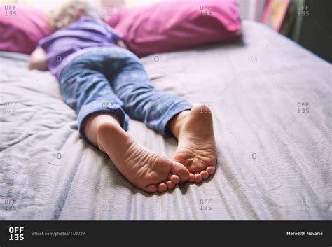 Close Up Of The Feet Of A Sleeping Girl Stock Photo OFFSET