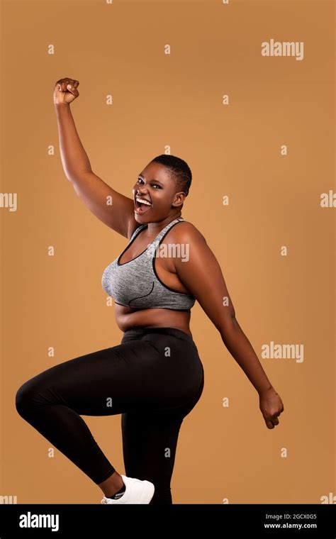 Portrait Of Emotional Black Chubby Woman Cheering And Dancing Stock