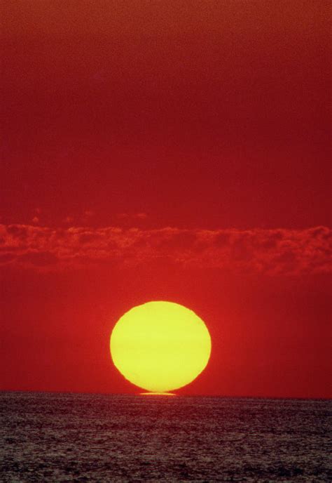 Sun Setting Over The Ocean Photograph By Ron Reidscience Photo Library