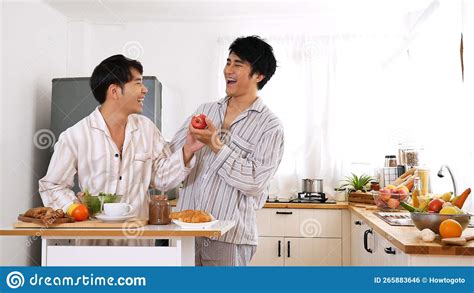 Happy Gay Couple Enjoy Breakfast In Kitchen Drinking Coffee Two Best Friends Lgbtq Relation
