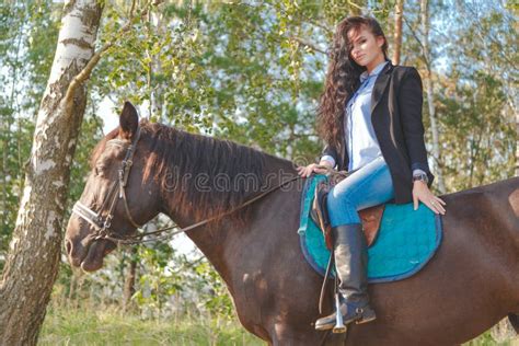 Beautiful Brunette Wearing Jeans Blouse And Black Jacket Riding A