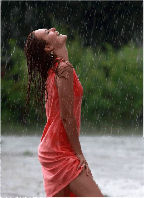 A Woman Standing In The Rain With Her Eyes Closed