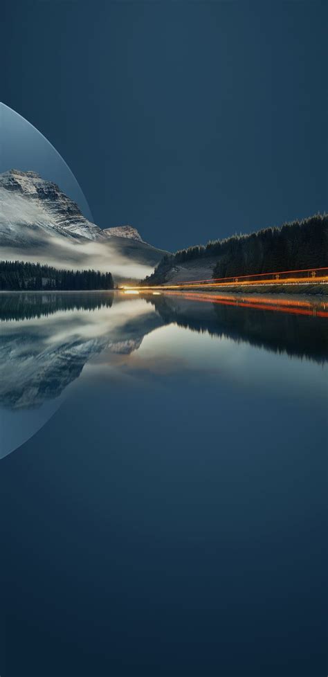 An Image Of The Night Sky And Water With Mountains In The Background