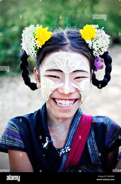 Smiling Girl Wearing Thanaka Paste On Her Face And Flowers In Her Hair