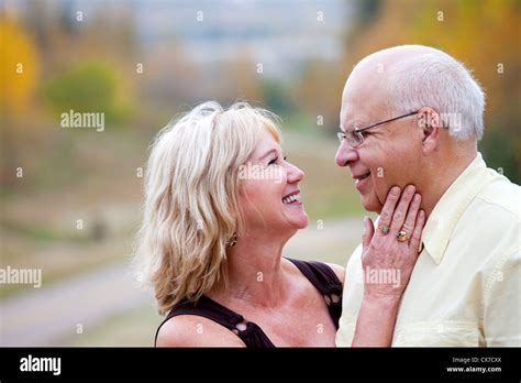 Mature Married Couple Enjoying Spending Time Together In Park During Fall Season Edmonton