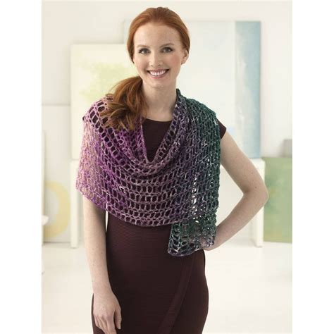 A Woman Wearing A Crocheted Shawl With Her Hands On Her Hips Smiling At