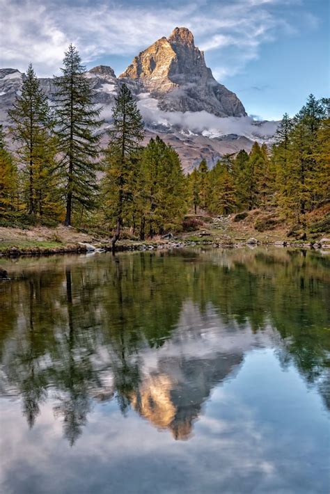 The Matterhorn Cervinia At Sunset Reflected In Lake Blue Just