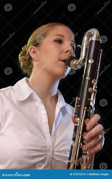 Pretty Young Woman Playing Bass Clarinet Royalty Free Stock Photo