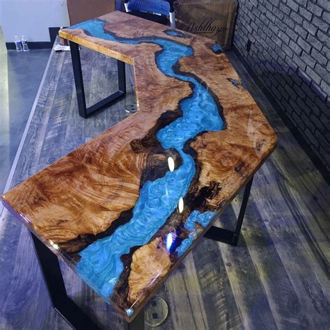 A Table That Is Made Out Of Wood And Has Blue Water Running Down The Side