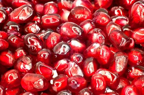 Extreme Close Up Background Of A Red Juicy Ripe Pomegranate Fruit Seeds