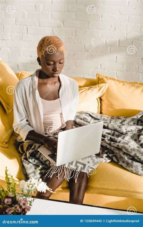 Concentrated African American Woman Typing On Laptop In Stock Image