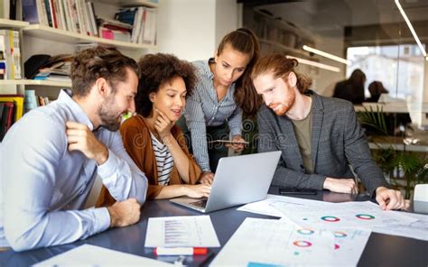 Group Of Business People Collaborating On Project In Office Stock Photo