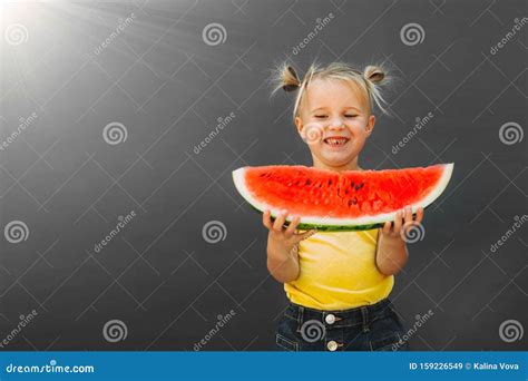 Funny Kid Eating Watermelon Outdoors On The Gray Backgrounds Stock