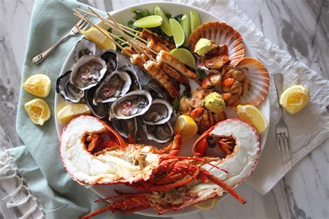 Seafood platter with fresh lobster, oysters, charred lime prawns and ...