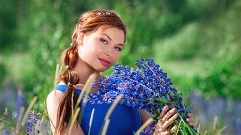 Portrait Of Young Beautiful Ginger Woman With Bouquet Of Blue Summer