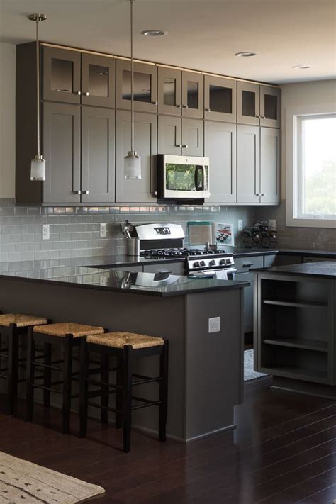 So often the ceiling is forgotten as decorative space and instead only viewed as a form of cover. These glass-front kitchen cabinets extend to the full ...