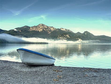 Abandoned Fishing Boat On Bank Of Alps Lake Morning Lake Stock Image