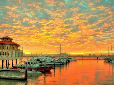 Sunset Red Sky With Cloud Reflection In Water Harbor For Yachts And