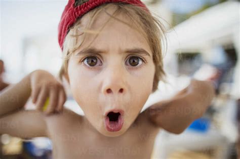 Portrait Of Little Boy Pulling Funny Faces Stock Photo