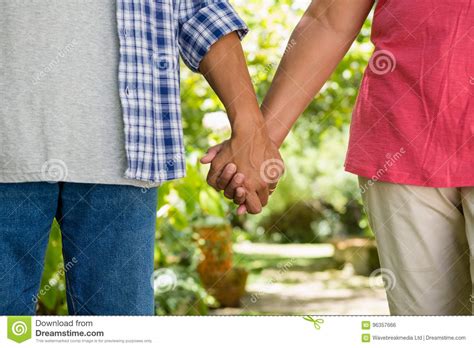 Mid Section Of Senior Couple Holding Hands Stock Photo Image Of