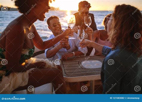 Group Of Friends Cheering With Drinks At Boat Party Stock Photo Image