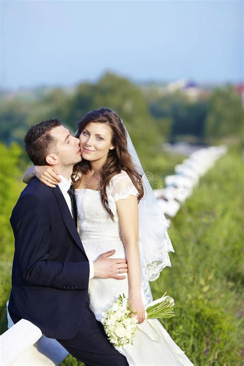 Happy Bride And Groom Kissing Smiling On Wedding Day Stock Photo