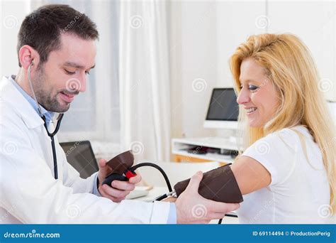 Young Attractive Doctor Checking Patient S Blood Pressure Stock Photo