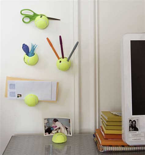 There Are Tennis Balls On The Wall Next To Some Scissors And Pictures
