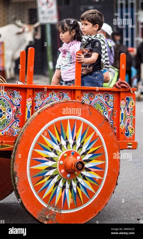 Young Boy And Girl Riding In A Colorful Hand Painted Ox Cart In A