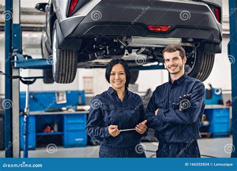 Auto Car Repair Service Center Two Happy Mechanics Man And Woman