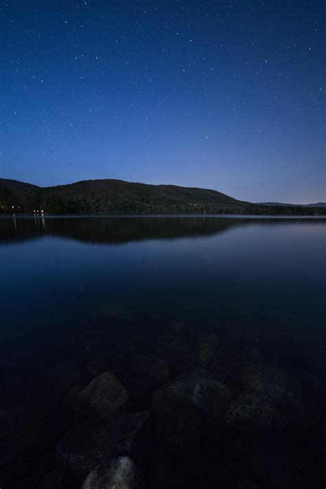 Lake View Under Clear Blue Night Sky During Night Time · Free Stock Photo