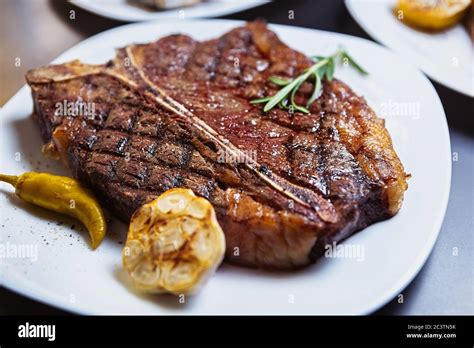 Medium Rare T Bone Steak Cooked On Grill Pan In American Restaurant