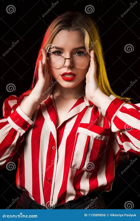 Stylish Blonde Girl In Glasses Wearing Striped Blouse Posing Wi Stock
