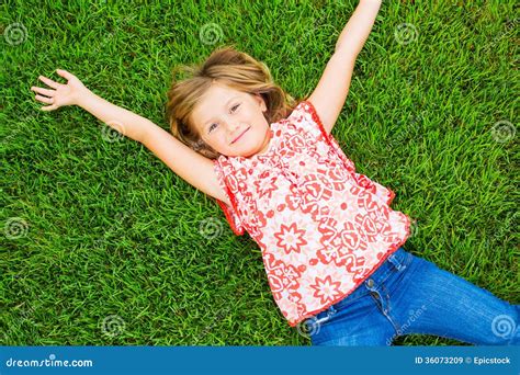 Smiling Little Girl Lying On Green Grass Stock Image Image Of Grass