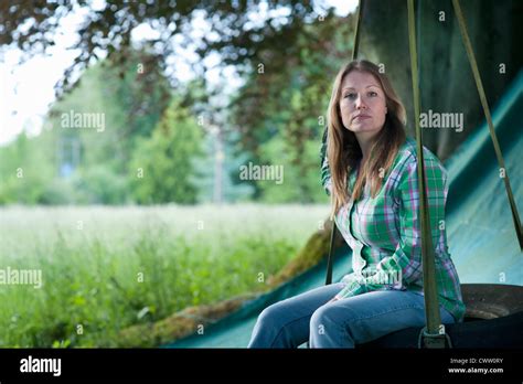 Woman Sitting In Tire Swing Outdoors Stock Photo Alamy